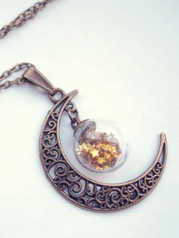 Bronze crescent moon globe necklace with glitter stars